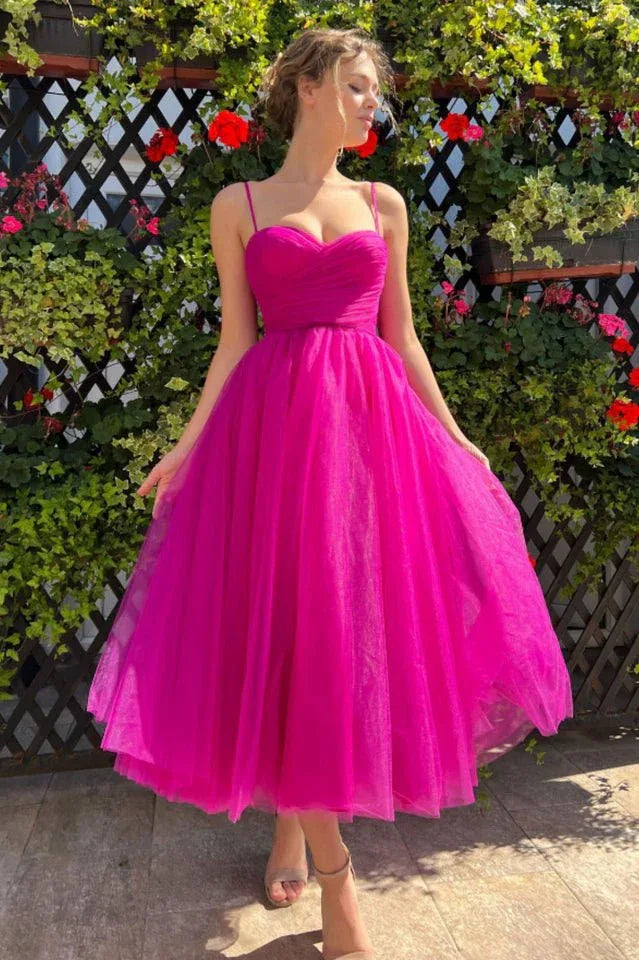 Full-length view of a woman in a vibrant pink tulle dress with a sweetheart neckline. Secondary image