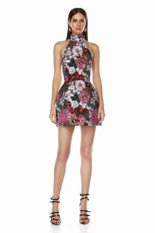 Full-length view of a model in a sequined floral halter mini dress