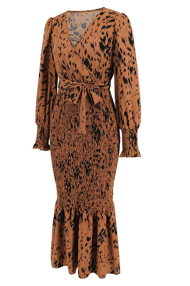 Angled product shot of a long-sleeved, brown and black animal print midi dress with a v-neck, tie waist, and ruffled hem.