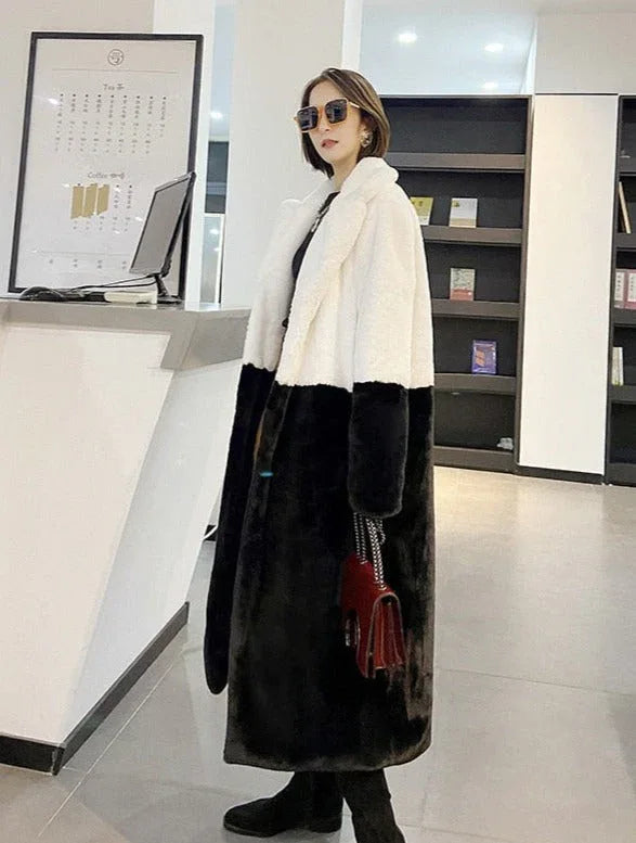 Woman wearing a white and black colorblock faux fur coat