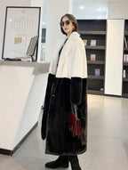 Woman wearing a white and black colorblock faux fur coat