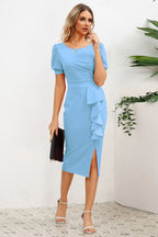 woman in blue sheath dress with ruffled skirt and slit