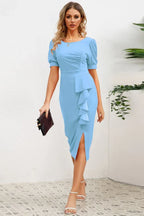 woman in blue sheath dress with ruffled skirt and slit