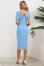 back view of woman in blue sheath dress