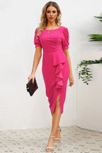 woman in pink sheath dress with ruffled skirt and slit