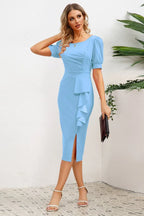 woman in blue sheath dress with ruffled skirt and slit