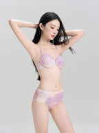 Woman wearing a purple and pink tie-dye bikini set.
