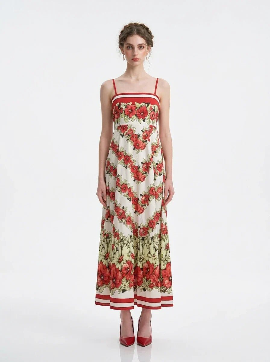 Woman wearing a floral print maxi dress with spaghetti straps, standing against a white background.