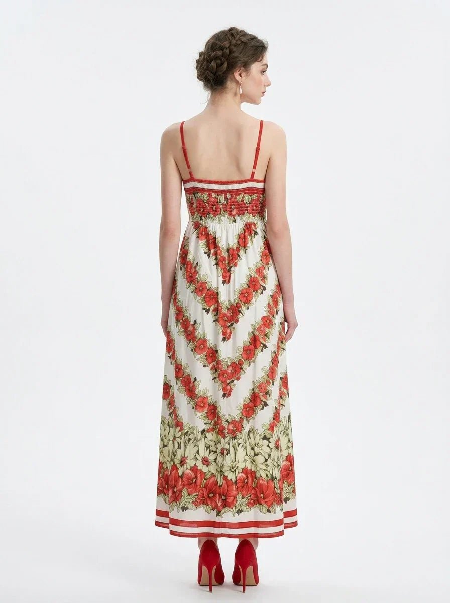Back view of a woman in a floral print maxi dress with spaghetti straps, standing against a white background.