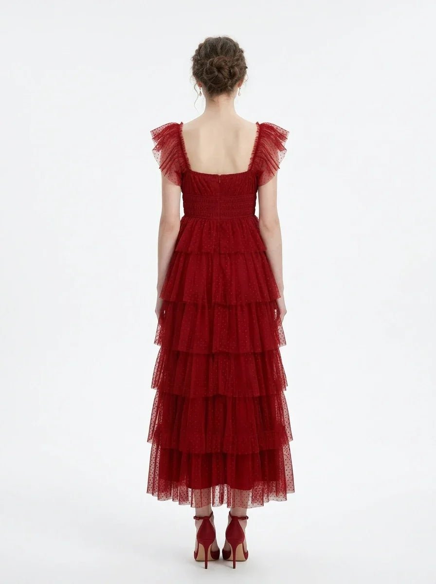 Woman in a red tiered tulle dress with ruffled sleeves and a square neckline, back view