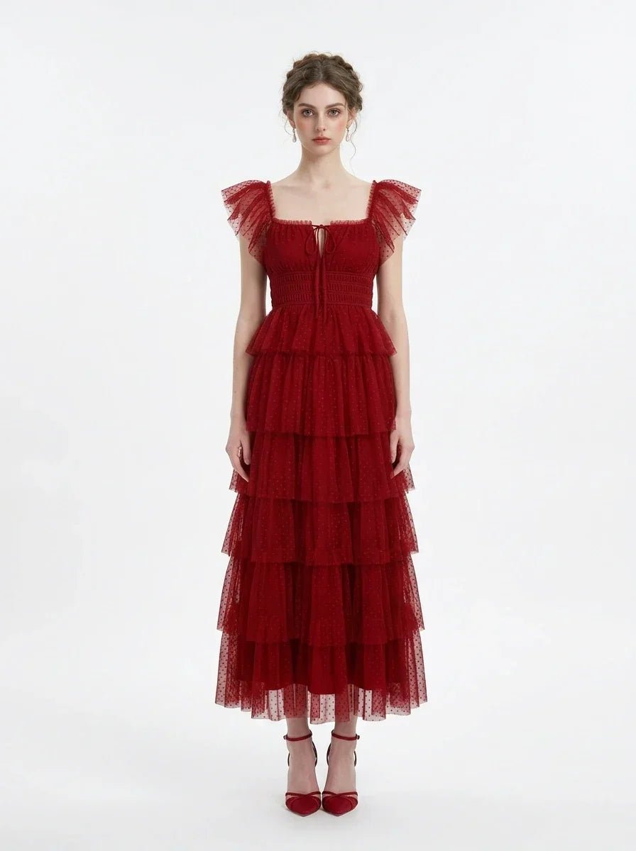 Woman in a red tiered tulle dress with ruffled sleeves and a square neckline, front view