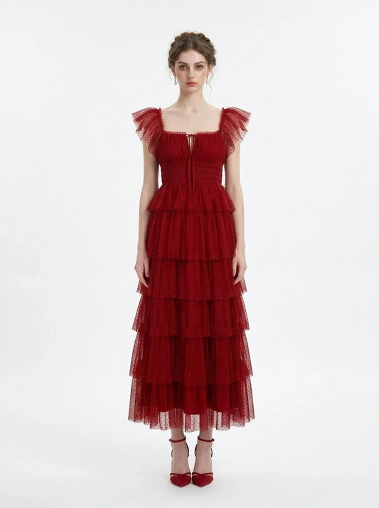 Woman in a red tiered tulle dress with ruffled sleeves and a square neckline, front view