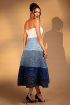 Back view of a woman in a white and blue ombre textured midi dress