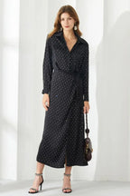 Woman in a black polka dot midi dress with a belt