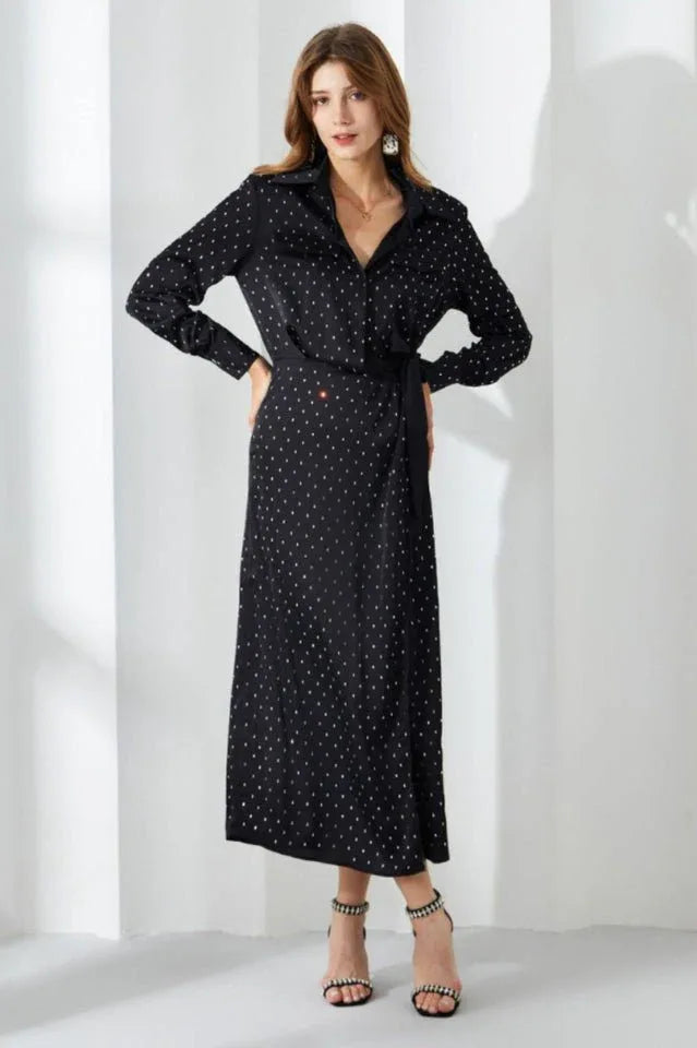 Full length view of a woman in a black polka dot shirt dress