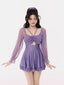 Model wearing a purple one-piece swimsuit with a skirt overlay and long sheer sleeves.