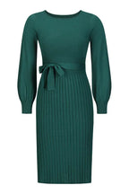 Product shot of a long-sleeved green pleated midi dress with a tie waist.