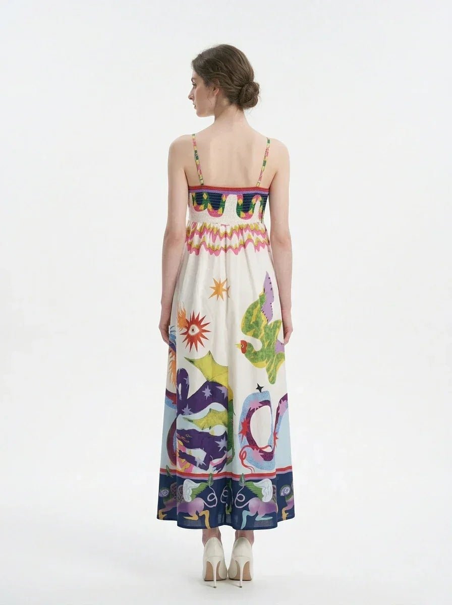 Woman wearing a white sleeveless maxi dress with a colorful graphic print and spaghetti straps, back view